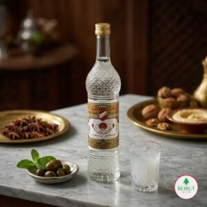 Botella de cristal de Arak Touma (750 ml) con grabados geométricos y etiqueta dorada con un emblema rojo.